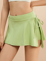 Lime wrap-detail skort with side tie closure and athletic fit.