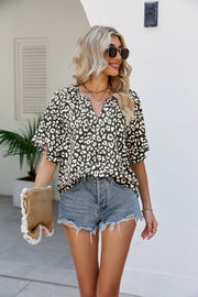 Black leopard print v-neck blouse with short sleeves and a relaxed fit.
