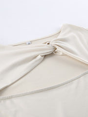 Beige knot front cutout long-sleeve shirt with a body-hugging fit.