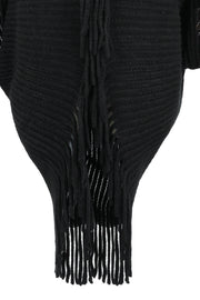 Black knit cape with fringe detail and open knit pattern.