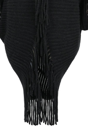 Black knit cape with fringe detail and open knit pattern.