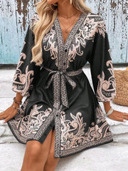 Black paisley mini dress with V-neck, billowy sleeves, and waist tie