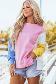 Colorblock split hem sweatshirt in pink, white, yellow, and blue with a crew neck and long sleeves.