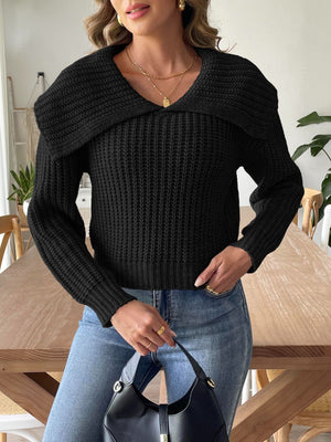 Black ribbed knit sweater with a dramatic shawl collar and long sleeves.