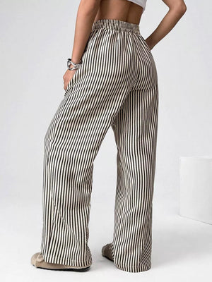 Navy striped high-waisted wide-leg pants with drawstring detail.