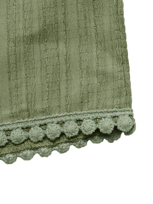 Crinkled wide-leg maternity pants in sage green with pom-pom trim detail.
