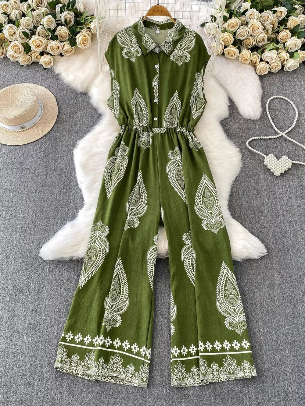 Green wide leg romper with white paisley print, collared, button-down, sleeveless, elastic waist