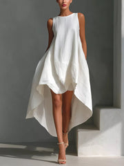White asymmetrical sleeveless flowing dress with a high-low hemline.
