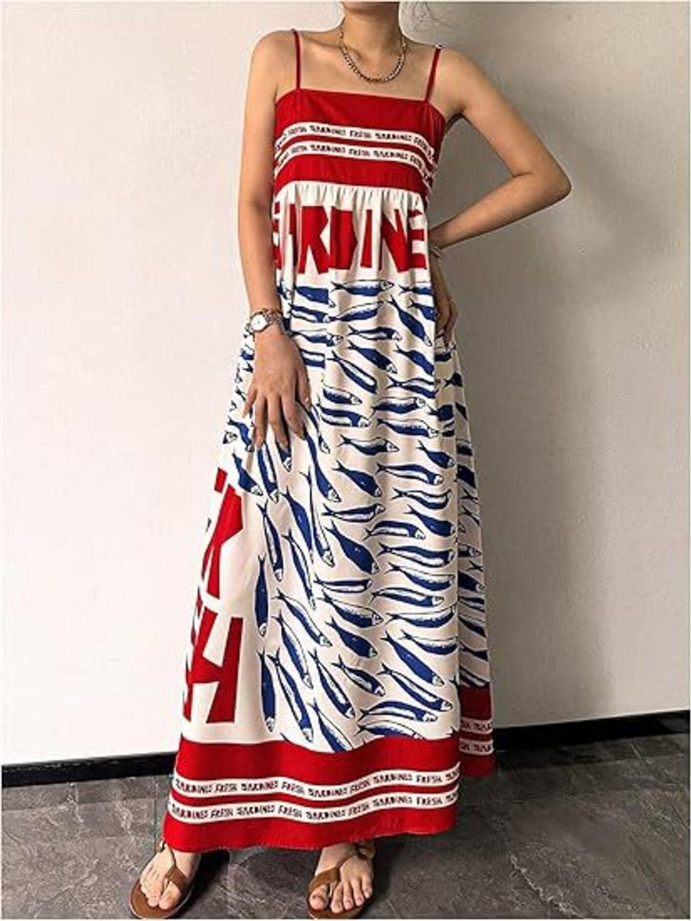 Spaghetti strap maxi dress with blue sardine print and red trim.