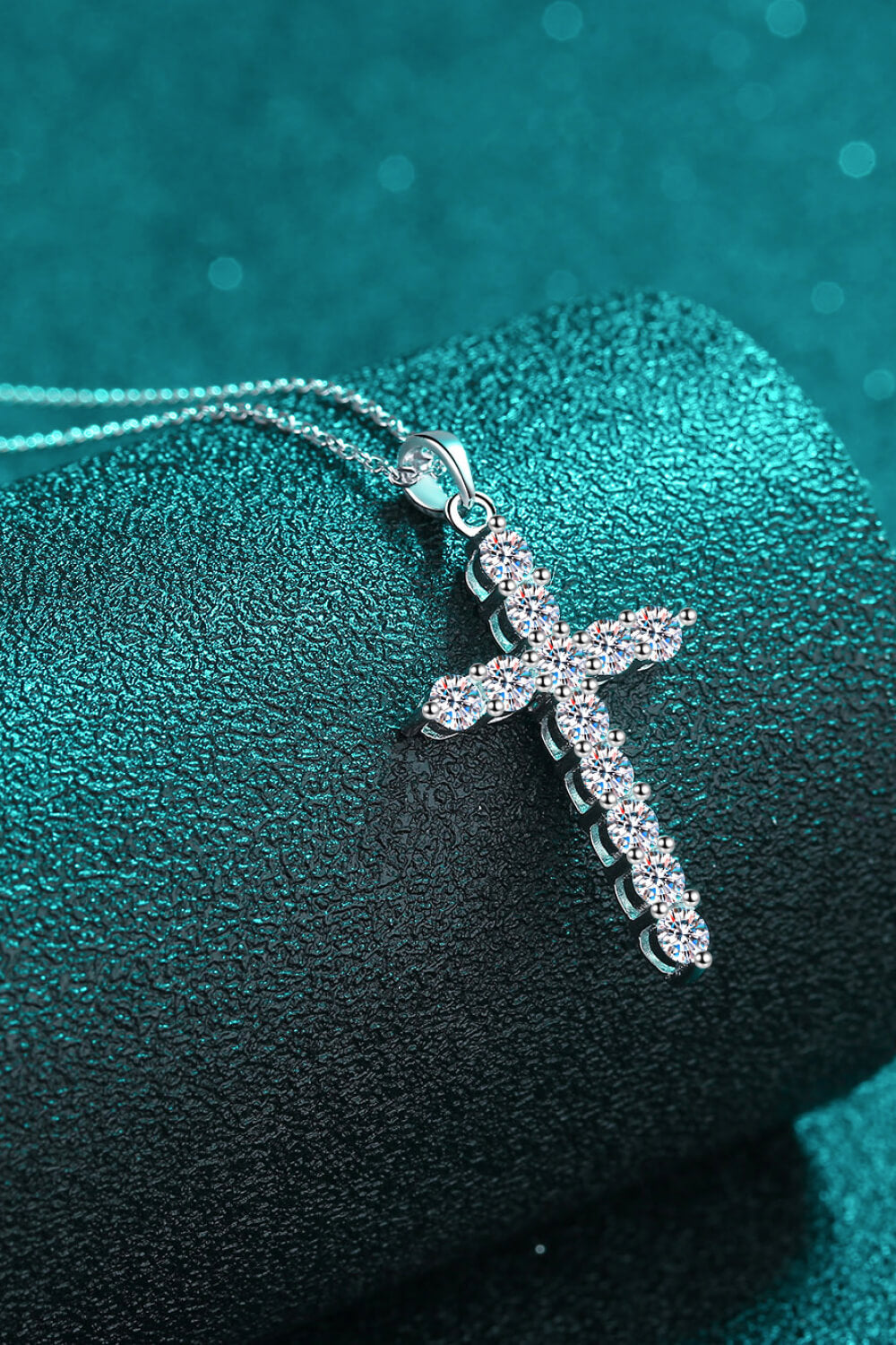 Silver pavé cross necklace with sparkling stones on a delicate chain.
