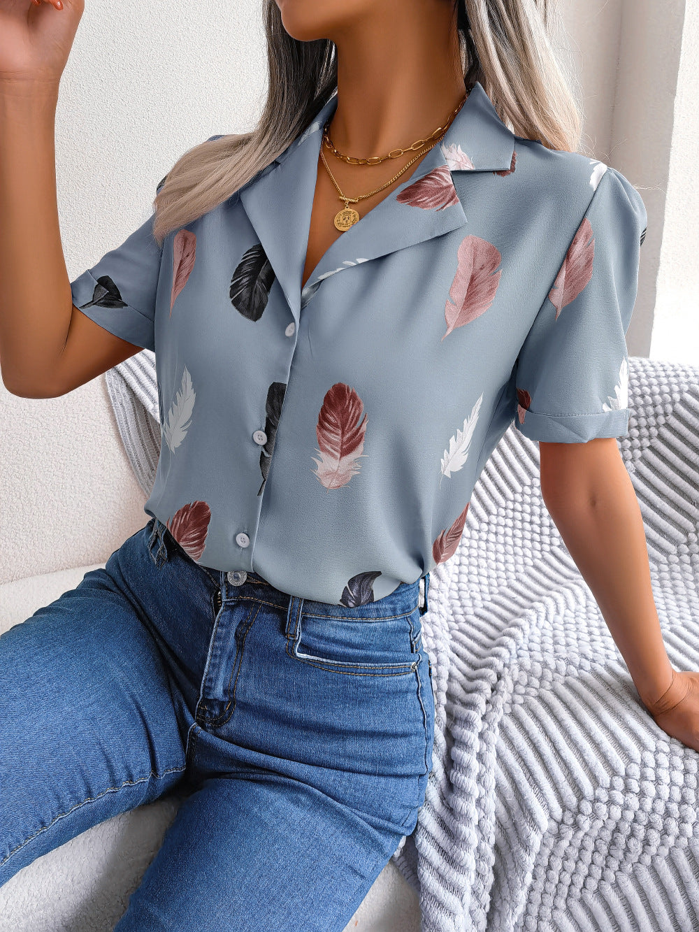 Light blue feather print collared puff sleeve blouse with button front.
