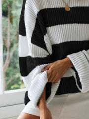 Black and white striped oversized knit sweater with ribbed texture and wide sleeves.