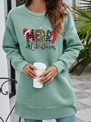 Sage green tunic sweatshirt with "Merry Christmas" graphic, crewneck, long sleeves, and side pockets.