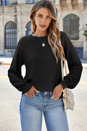 Black waffle knit raglan top with lace yoke detail and balloon sleeves.