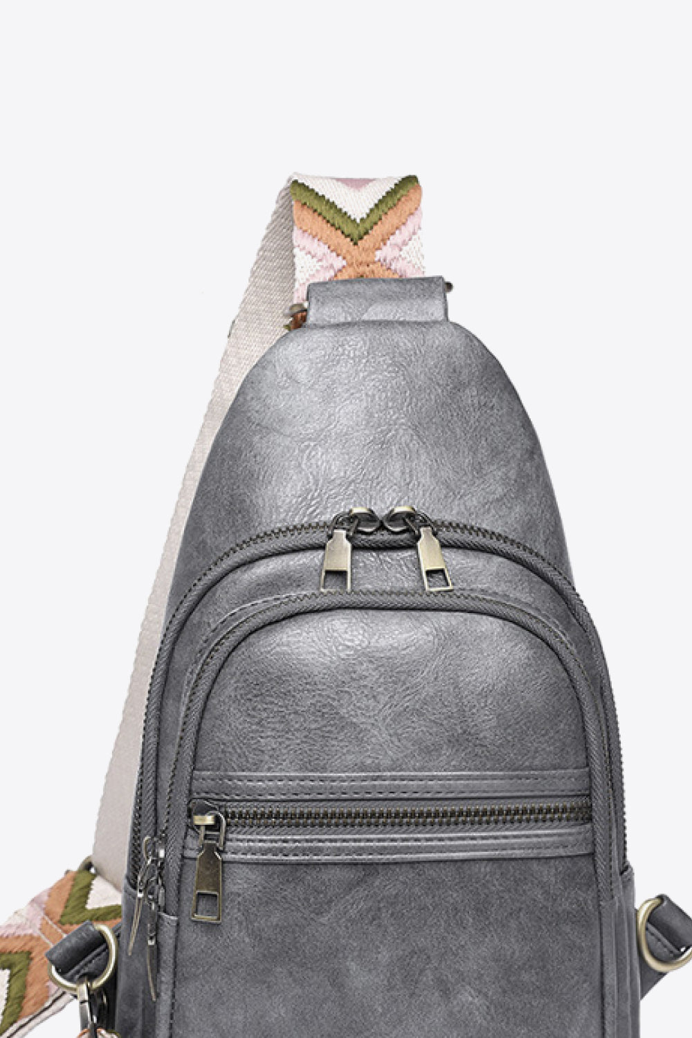 Geometric strap sling bag in Mid Gray with a colorful chevron strap and multiple zippered pockets.