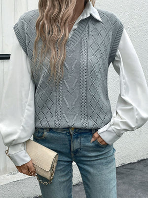Gray diamond knit V-neck vest with openwork details, layered over a white shirt and jeans.