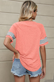 Raglan sleeve tee in watermelon pink with striped cuffs.