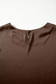 Brown satin maternity blouse with keyhole back detail and button closure.