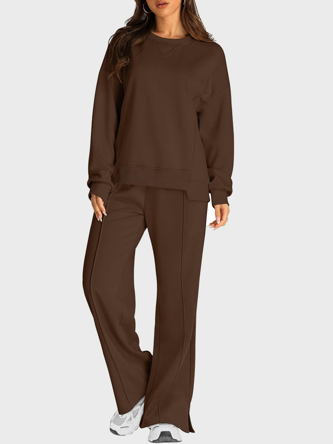 Brown seamed loungewear set with crewneck sweatshirt and slit-front trousers.