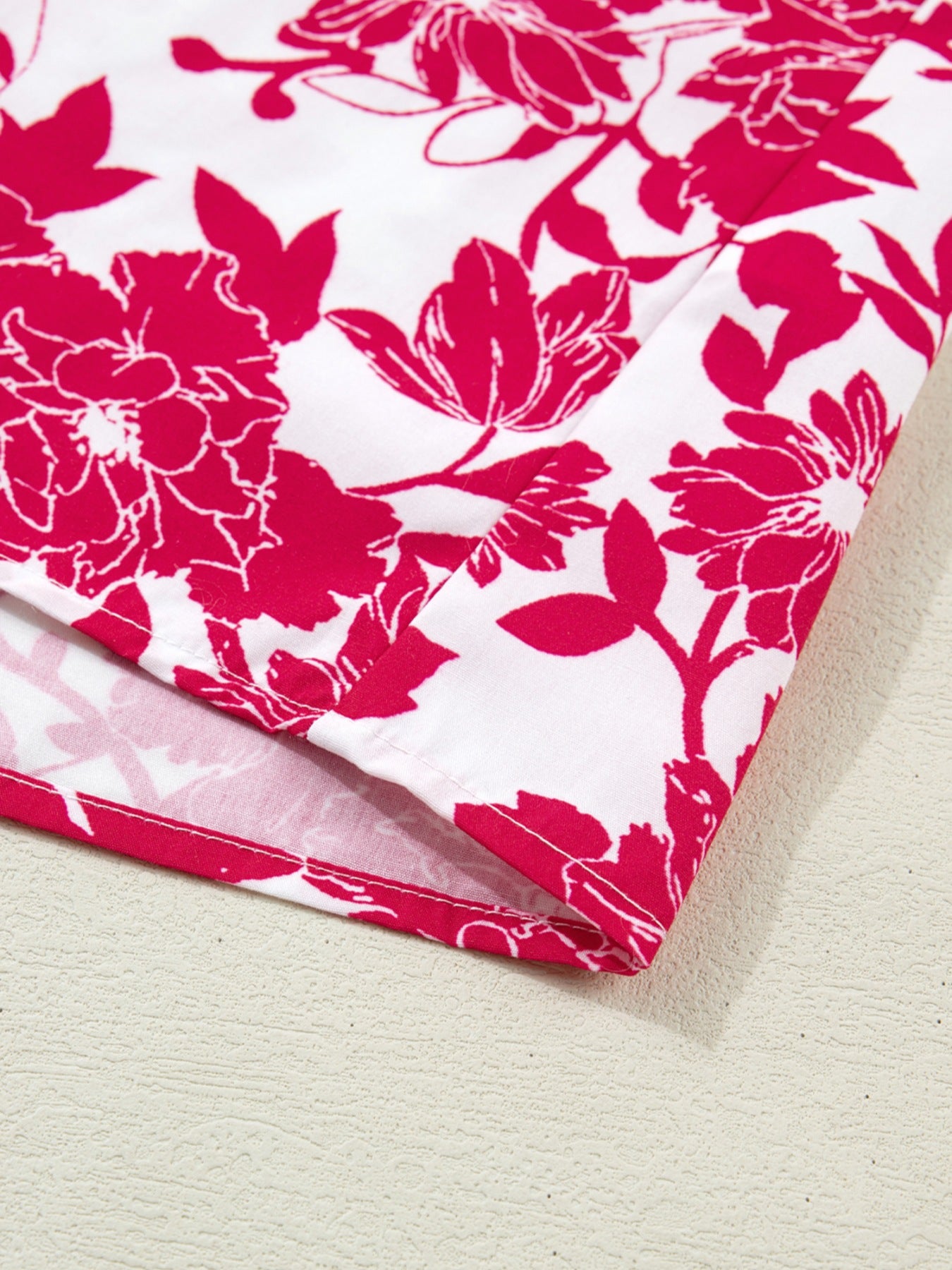 White polyester blouse with bold pink floral print and lace detail.