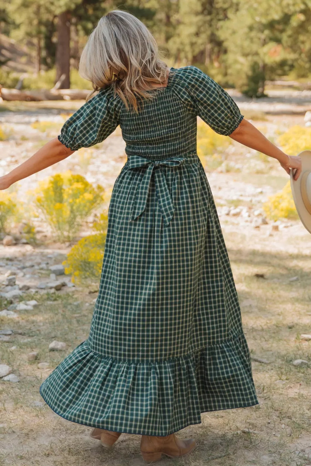 Green plaid cotton maxi dress with smocked bodice, puff sleeves, tie waist, and ruffled hem.