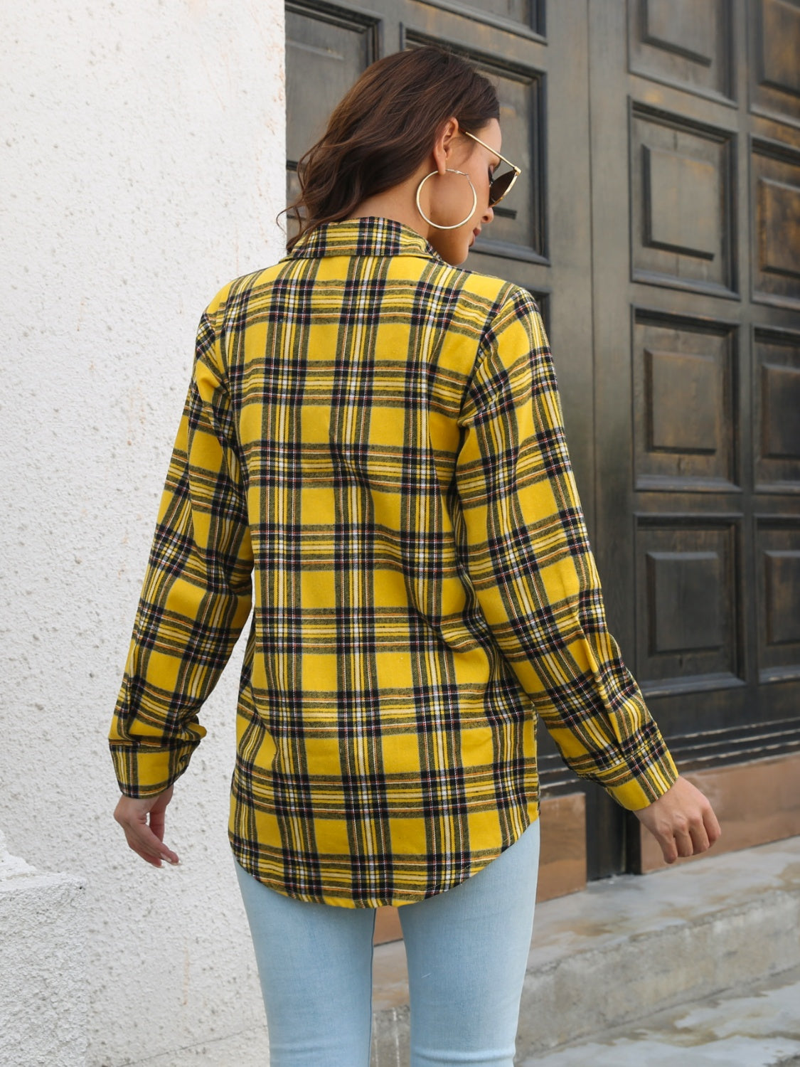 Yellow plaid overshirt with buttoned cuffs and flap pockets, worn by a woman.