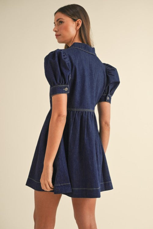 Dark denim mini dress with puff sleeves and A-line skirt.