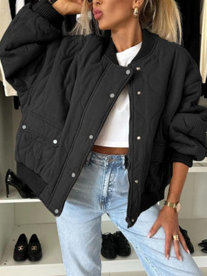 Black quilted bomber jacket with rounded sleeves and snap front closure.