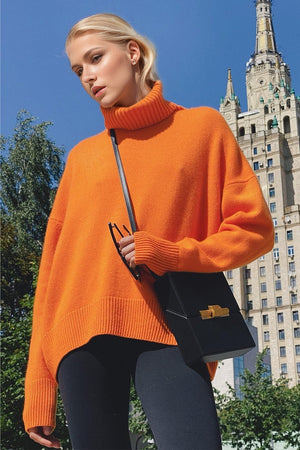 Orange oversized cashmere turtleneck sweater with ribbed cuffs and hem.