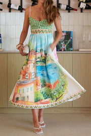 Midi dress with green gingham bodice, scenic print skirt, and decorative hem.