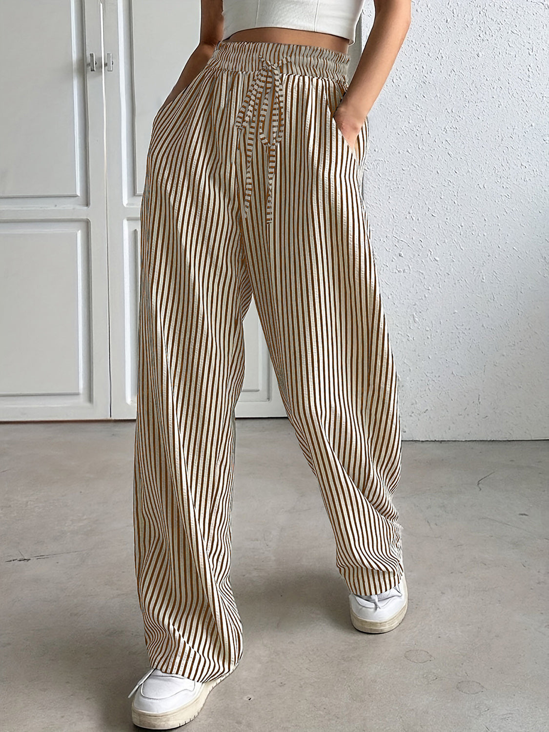 Wide-leg trousers with vertical stripes and drawstring waist, shown in Tan.
