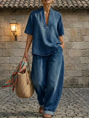 Blue denim V-neck top and wide-leg pants set with cuffed ankles and curved hem.