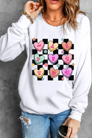 White sweatshirt with conversation heart graphic and checkerboard pattern