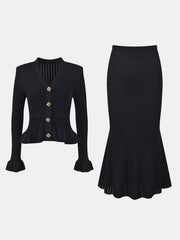 Black knit cardigan with ruffled hem and bell sleeves, paired with a matching midi skirt.