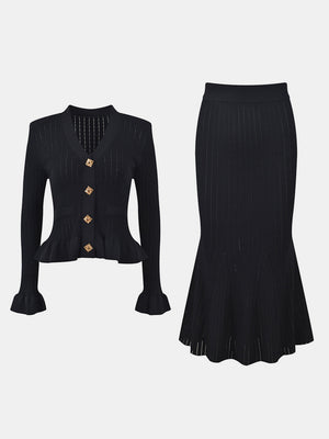 Black knit cardigan with ruffled hem and bell sleeves, paired with a matching midi skirt.