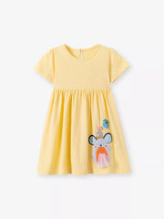 Yellow polka dot cotton blend toddler dress with cartoon dog applique and short sleeves.