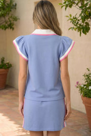 Chic blue polo tee with pink and white trim and matching drawstring skirt.
