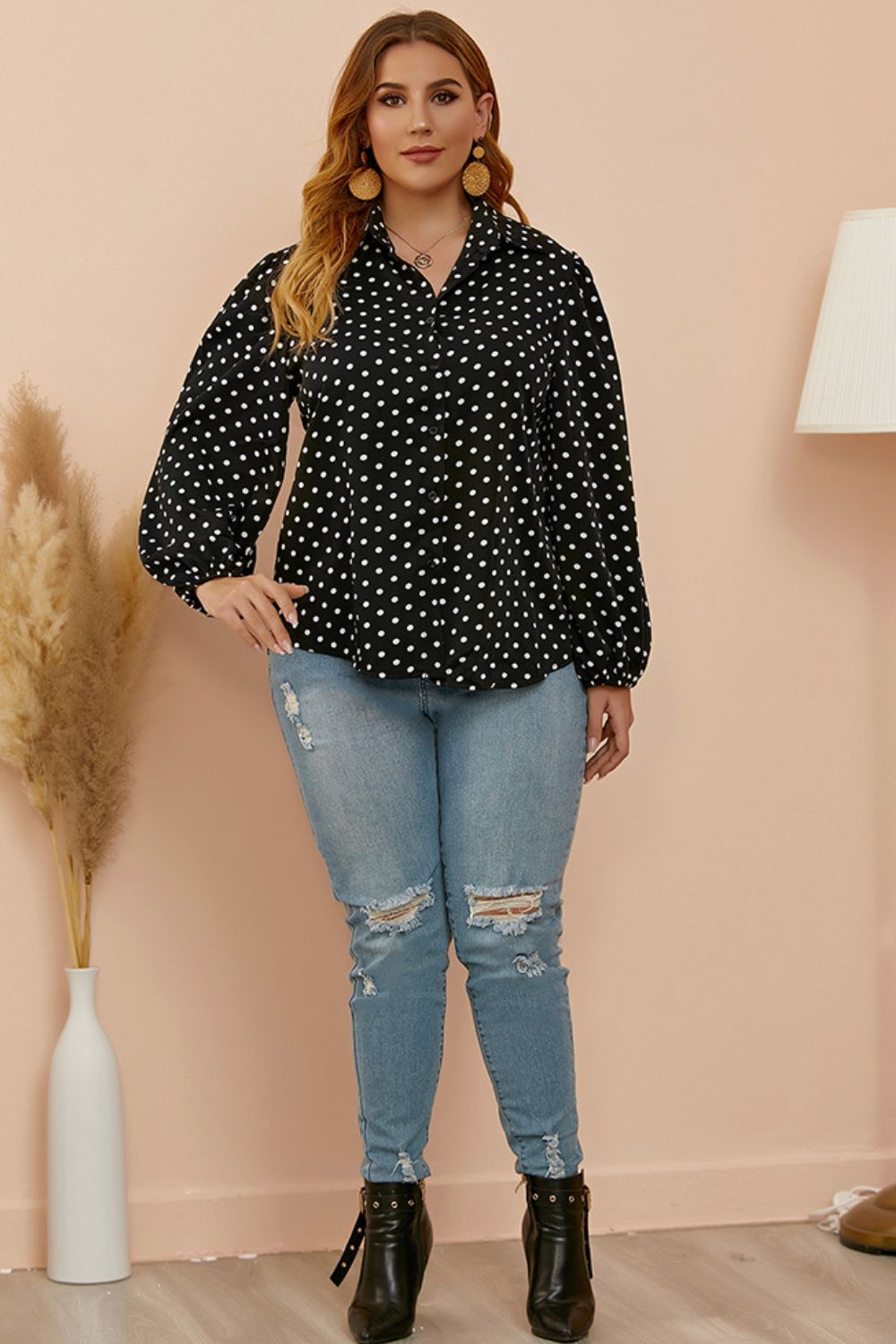 Black polka dot blouse with shirred balloon sleeves and a collared neckline.