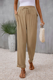 Khaki textured trousers with drawstring waist and cuffed hems