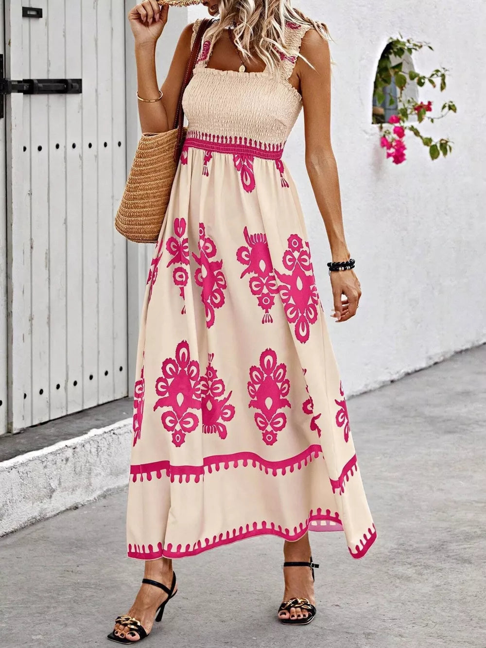 Smocked square neck maxi dress in tan with pink floral print, a-line cut, and ruffled straps.