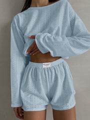 Light blue perforated crop top and shorts set with long sleeves and elastic waist shorts.
