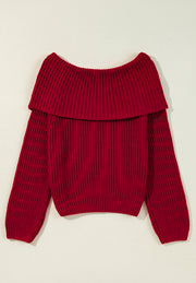 Deep red acrylic off-the-shoulder sweater with a ribbed neckline and long sleeves.