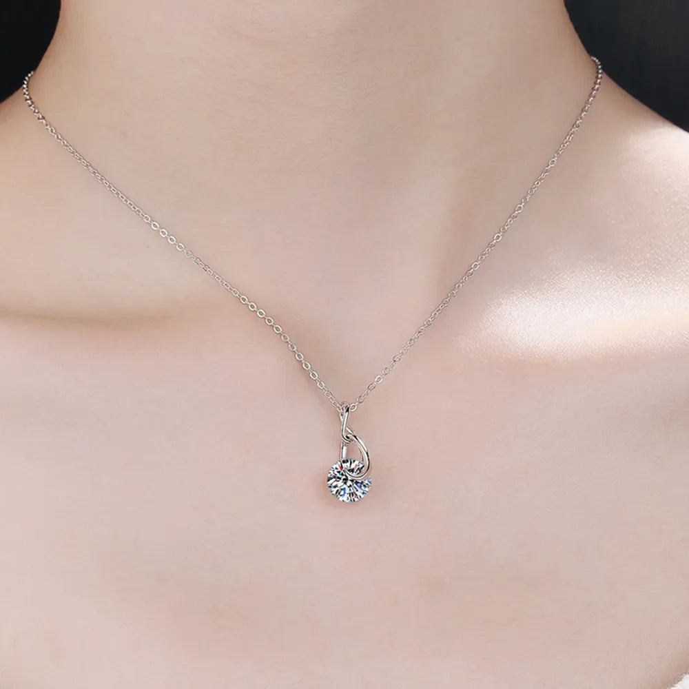 Silver solitaire pendant necklace with a delicate chain and a sparkling round cubic zirconia stone.