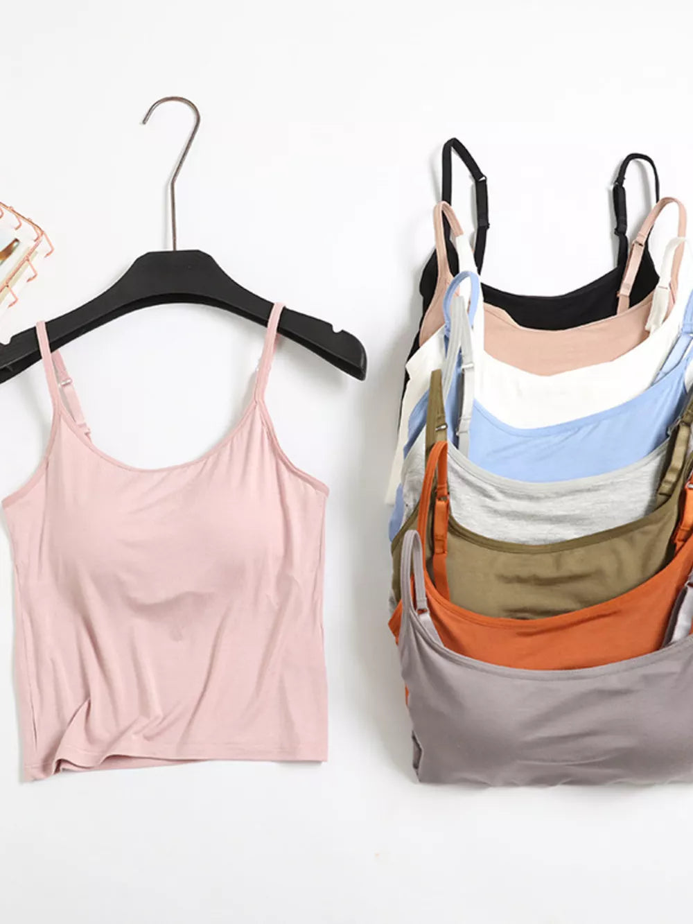 Pink cami with adjustable straps and a stack of camis in various colors including black, white, blue, grey, green, orange