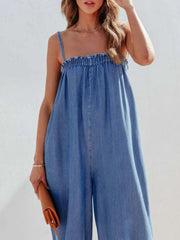Medium denim jumpsuit with gathered square neckline and wide legs.