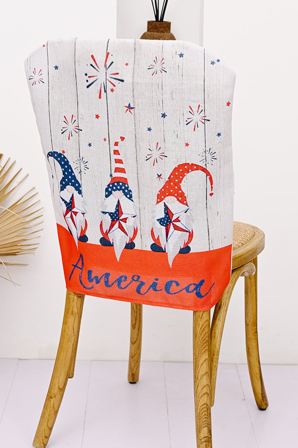Patriotic gnome chair cover with fireworks and stars, red and blue multicolor fabric.