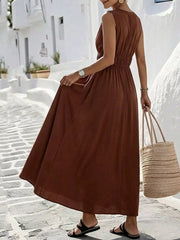 Brown V-neck sleeveless maxi dress with elastic waist and flowing skirt.