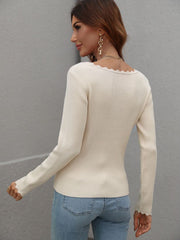 Cream ribbed knit top with scalloped neckline and cuffs.