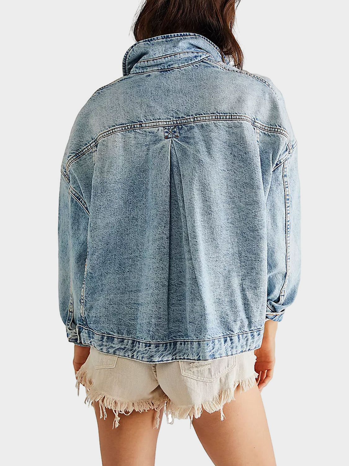 Light wash oversized denim trucker jacket with back pleat detail and buttoned cuffs.