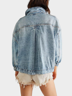 Light wash oversized denim trucker jacket with back pleat detail and buttoned cuffs.